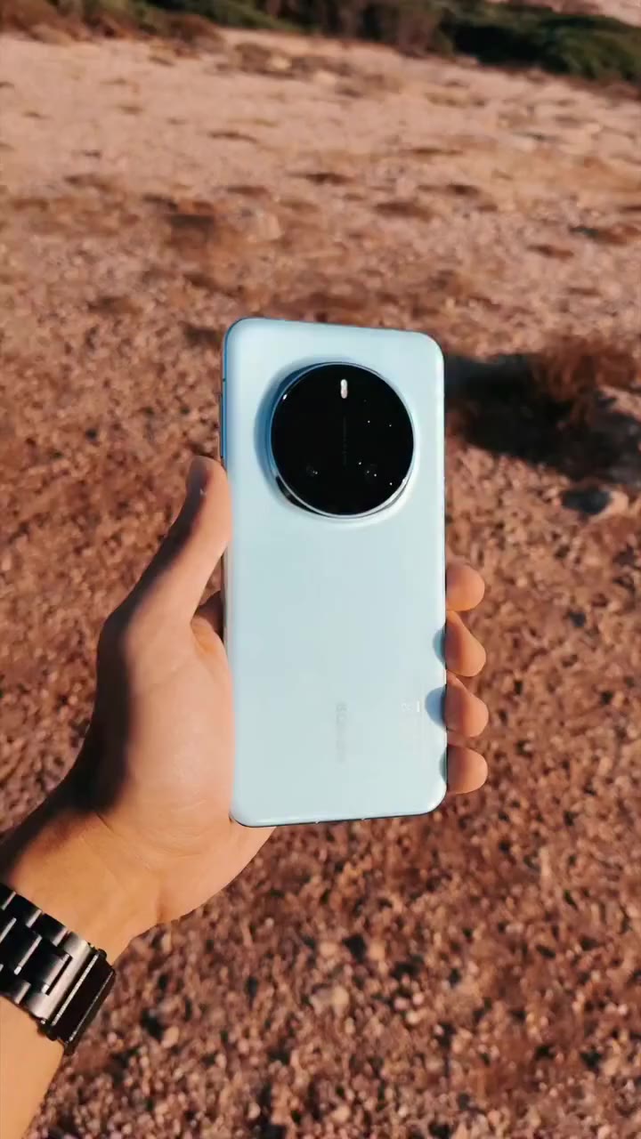 HONOR phone photographed against a warm natural landscape